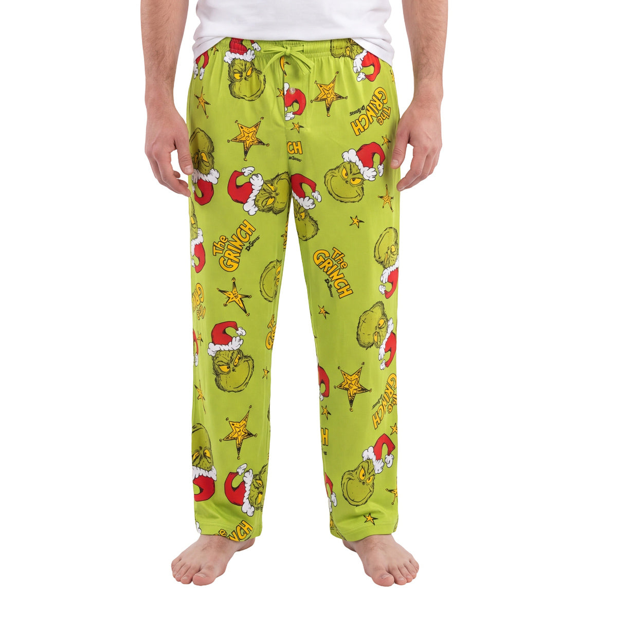 Green Grinch Starry Christmas lounge pants with Grinch and star print, front view worn barefoot