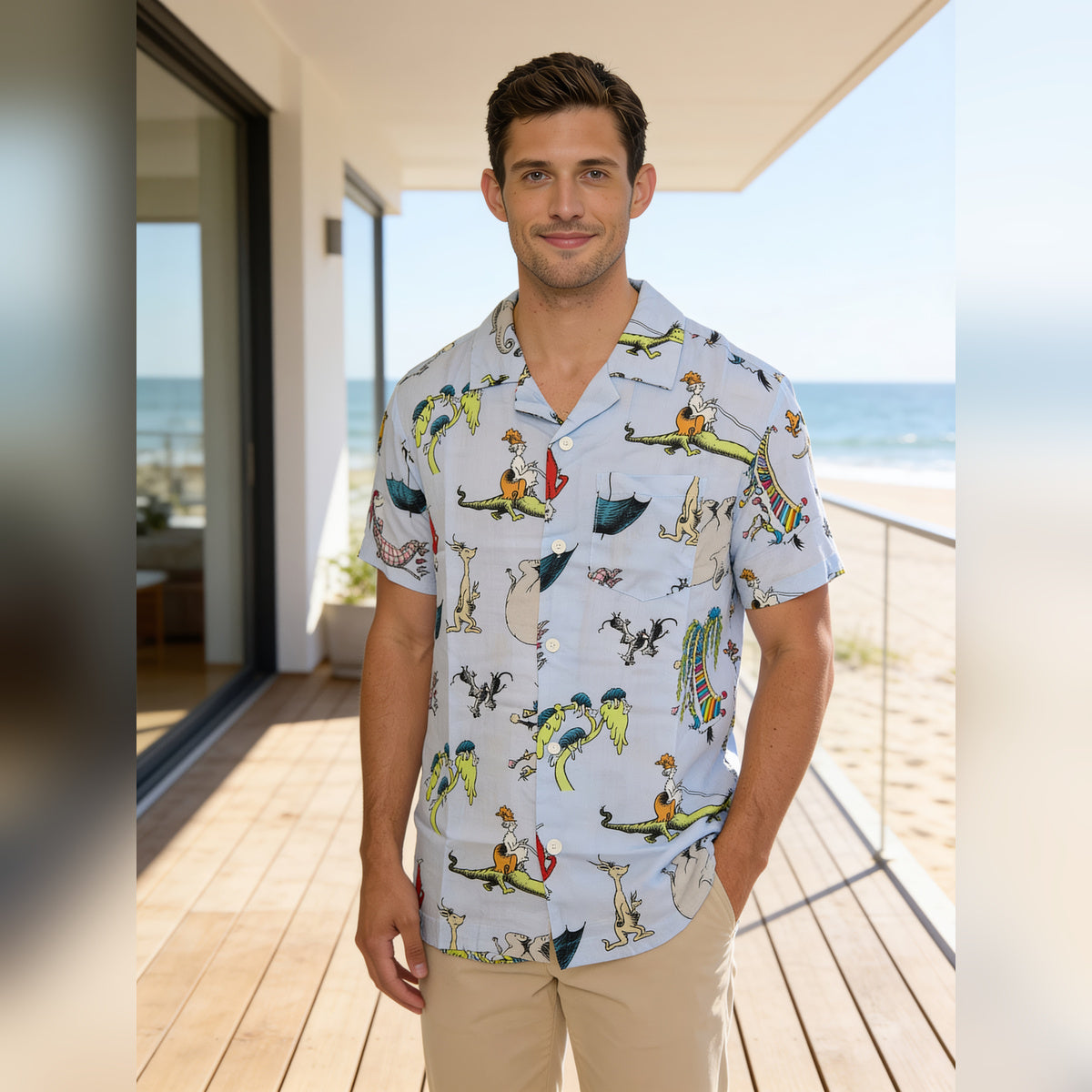 Man wearing the Dr. Seuss character print button up shirt on a beachside deck