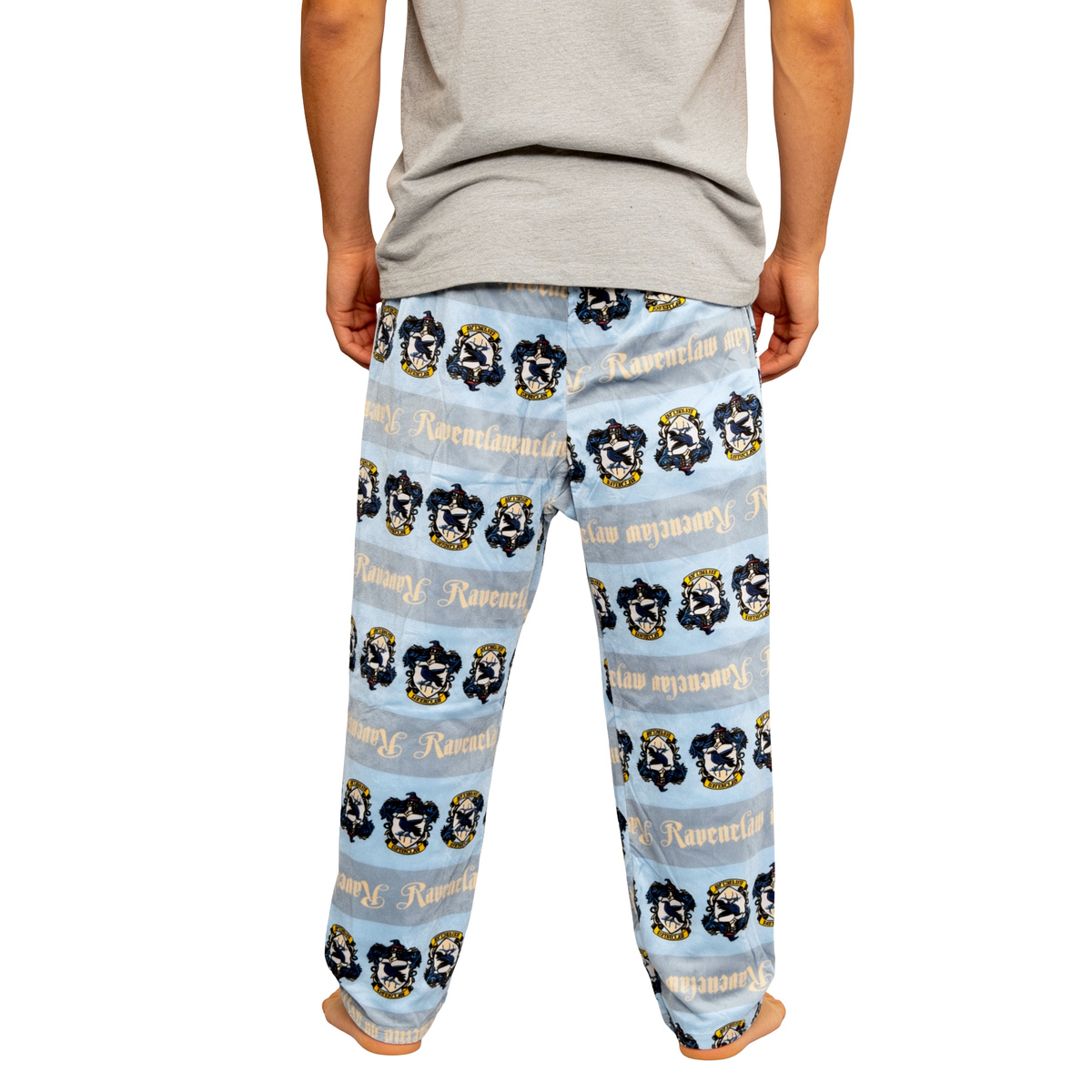 Man in a grey tee wearing the Ravenclaw sleep pants, front view from the waist down