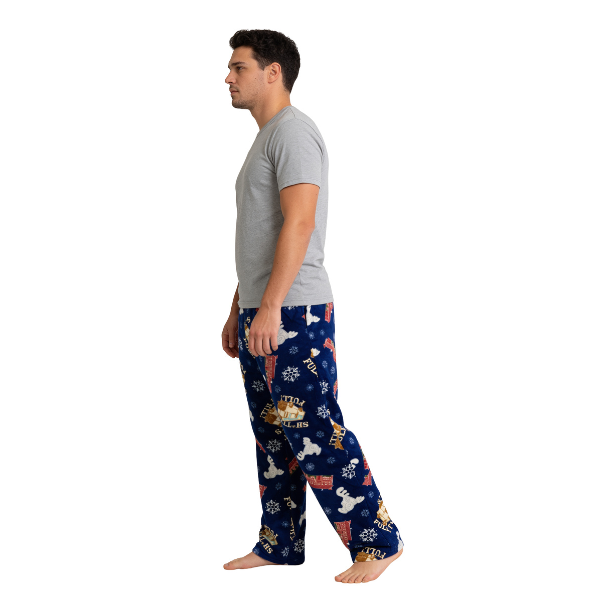 Man walking in the blue Christmas Vacation Icons sleep pants, side view on white