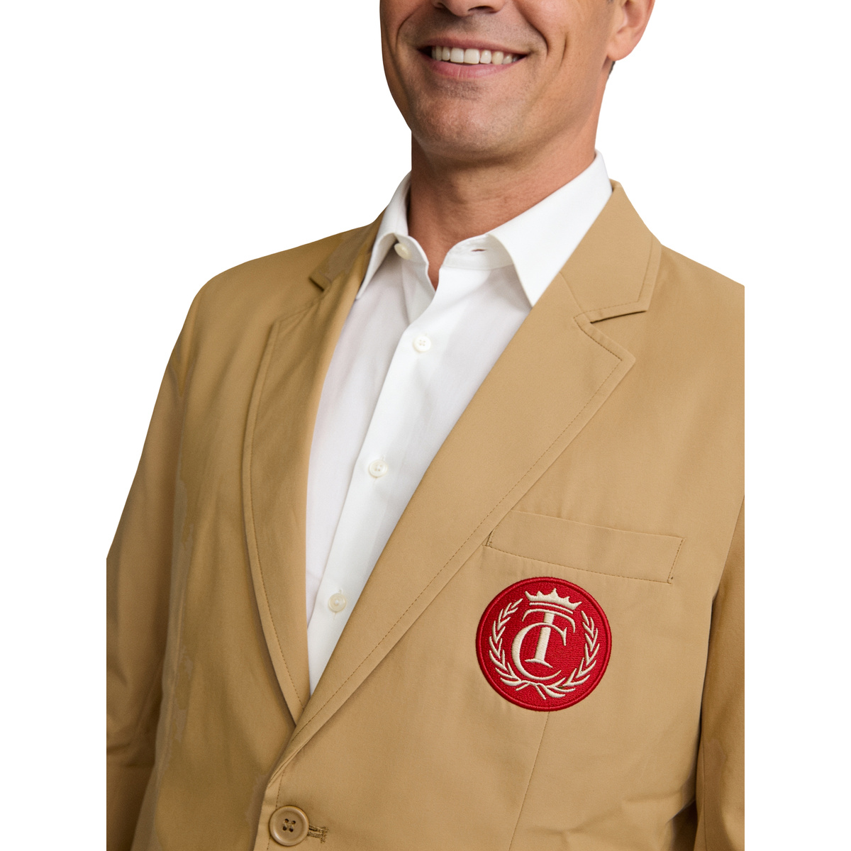 Close-up of the red embroidered crest patch on the tan Happy Gilmore costume jacket