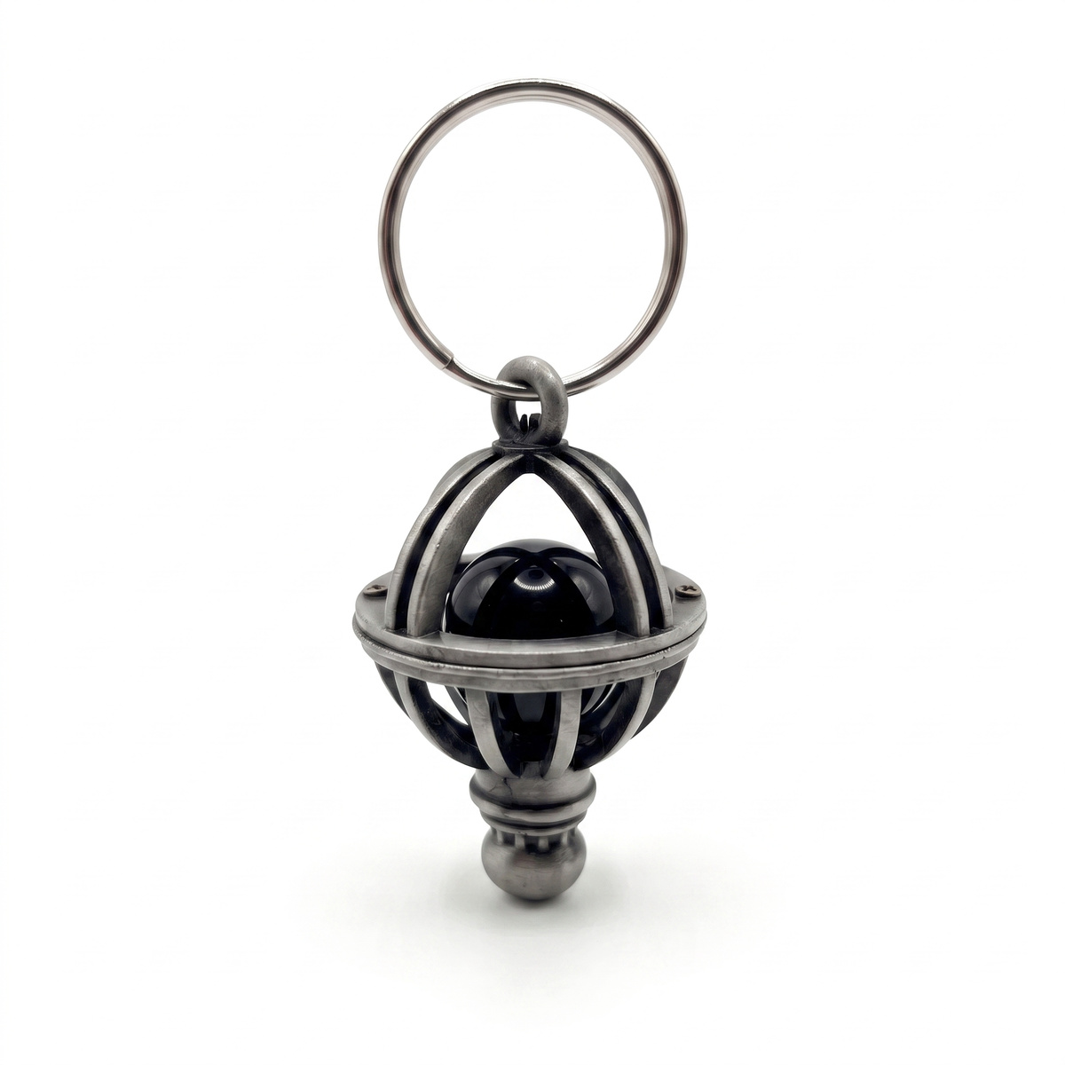 MIB replica Orion's Belt charm keychain with black marble in a silver cage on white background