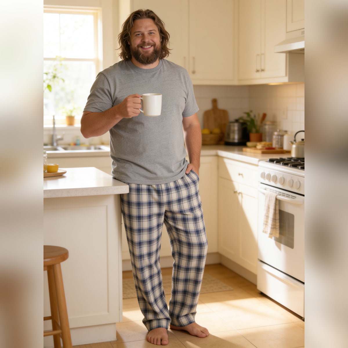 Man holding a mug in a sunny kitchen wearing the Thunder God plaid lounge pants