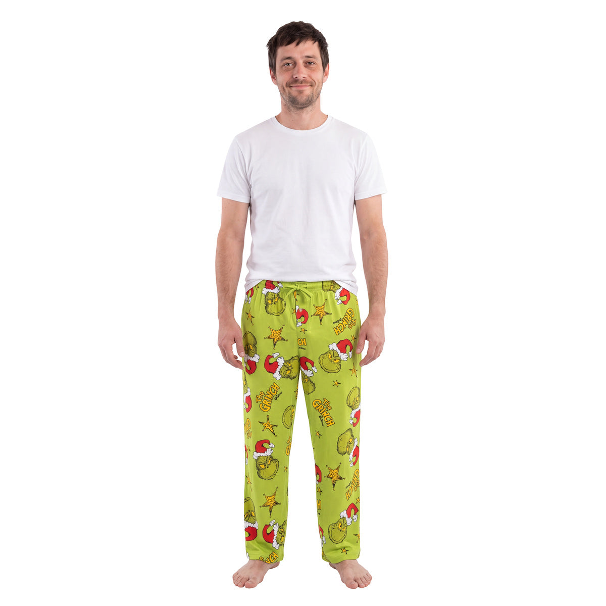 Man in a white tee wearing the Grinch Starry Christmas lounge pants, full front view on white