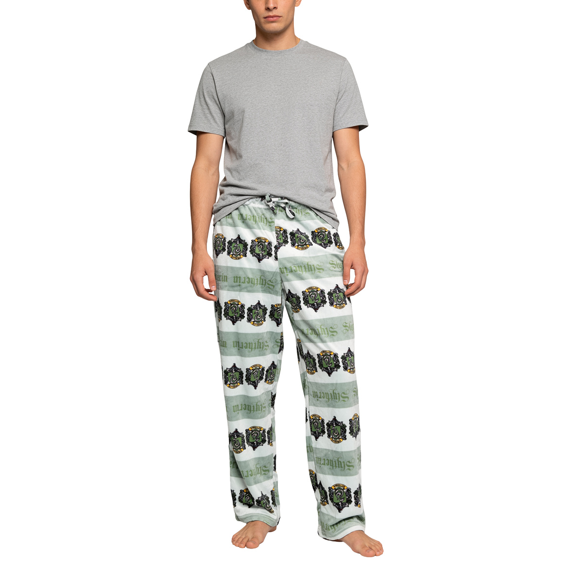 Man in a grey tee wearing the Slytherin sleep pants, full front view on white