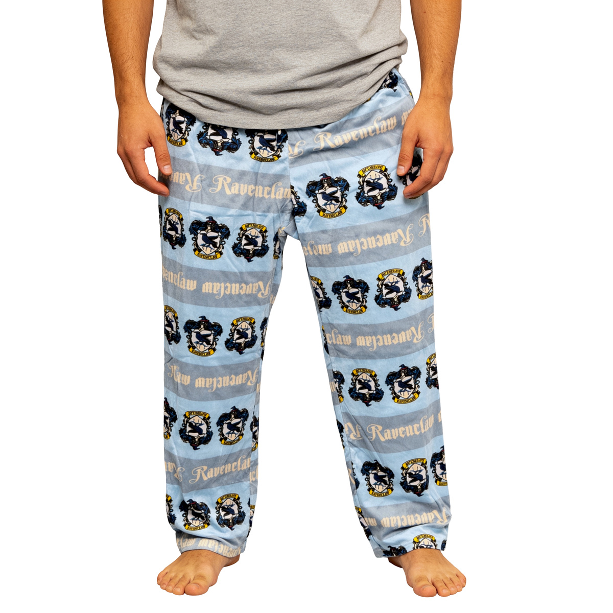 Blue Harry Potter Ravenclaw plush sleep pants with house crest print, front view worn barefoot