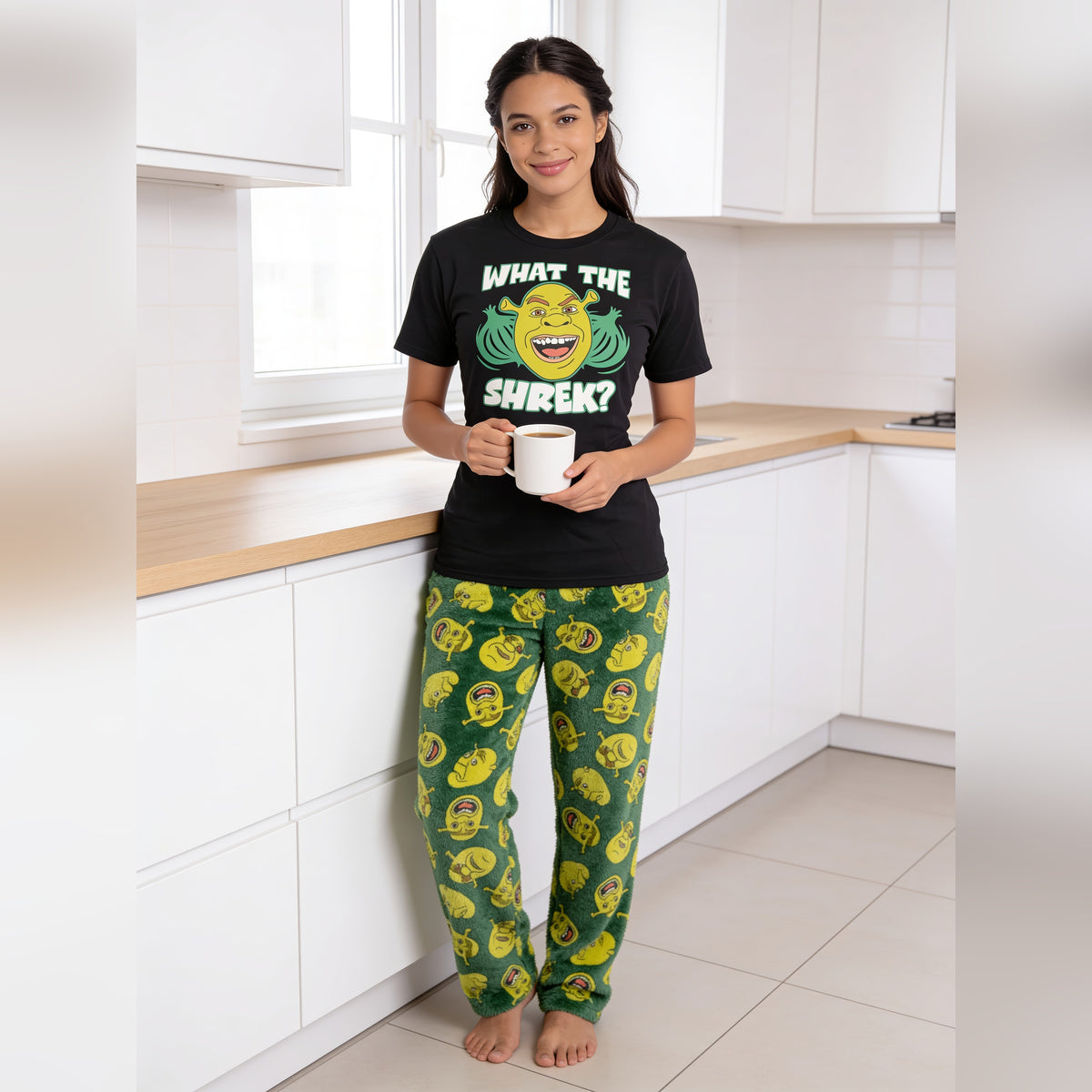Woman holding a mug in a kitchen in the Shrek What the Shrek sleep set