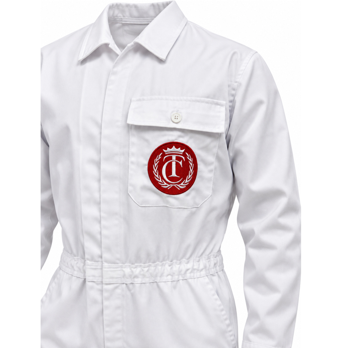 Close-up of the red embroidered crest patch on the white caddy jumpsuit chest pocket
