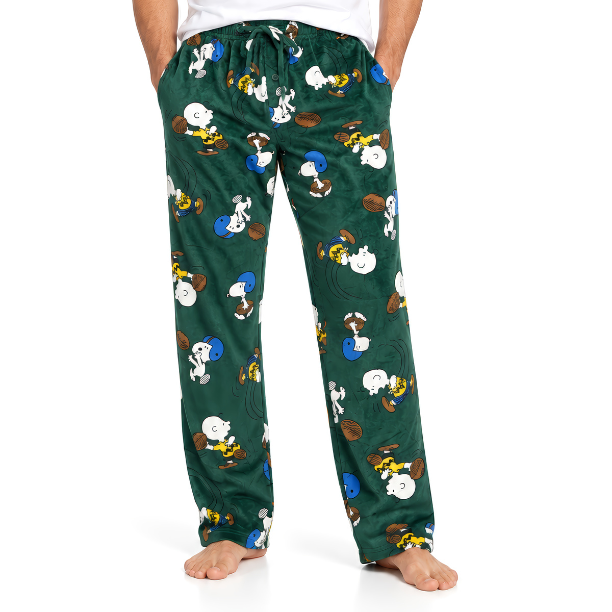 Green Peanuts Good Sport lounge pants with football print, worn barefoot, front view on white