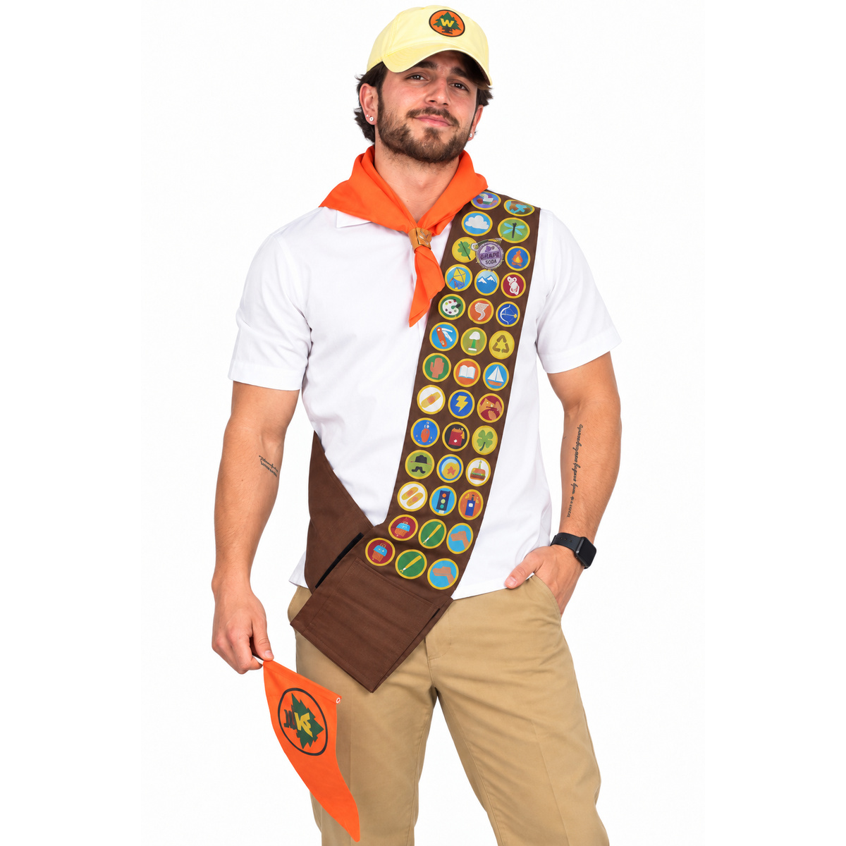 Man wearing Russel costume set: yellow cap, orange neckerchief and badge sash, on white background