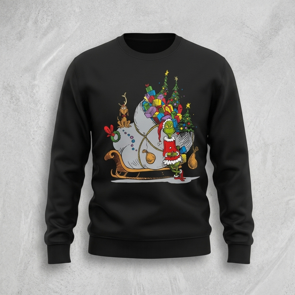 Grinch on Sleigh with Max Christmas sweater laid flat on a grey textured background